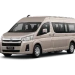 Toyota Hiace Premio coklat muda metallic tampak serong depan dan samping untuk layanan sewa Hiace Bandung dengan driver profesional