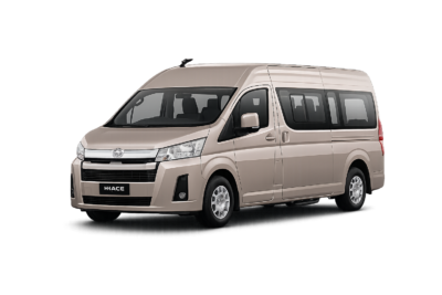 Toyota Hiace Premio Luxury coklat muda metallic tampak serong depan dan samping untuk layanan sewa Hiace Luxury Bandung dengan driver profesional
